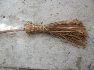 holding the brush material of an outdoor broom